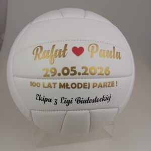 biała piłka siatkowa z ozdobnym nadrukiem z życzeniami dla młodej pary w kolorze złotym